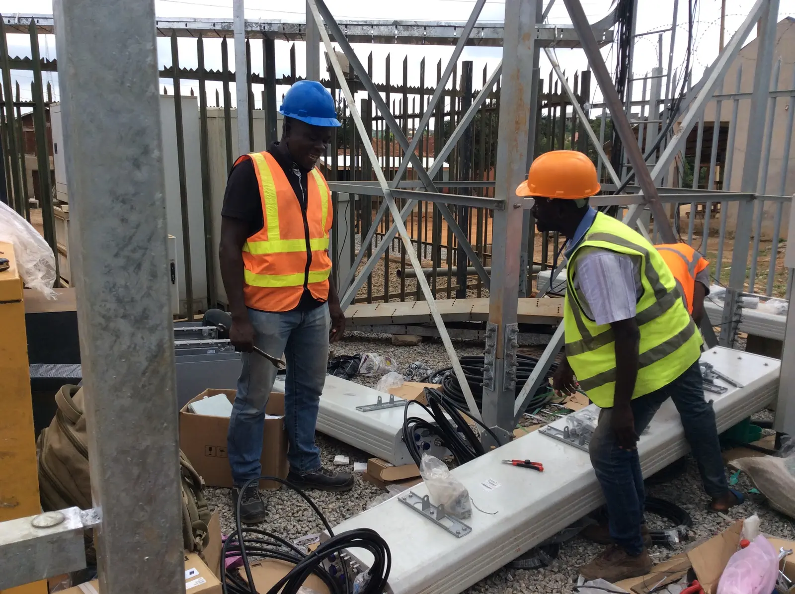 Engineering team installing telecommunications equipment at a field site