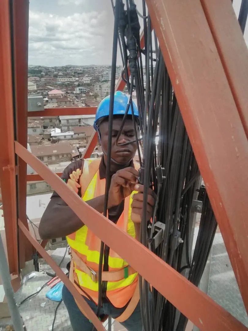 Kudos technician rigging telecommunications cables on a tower